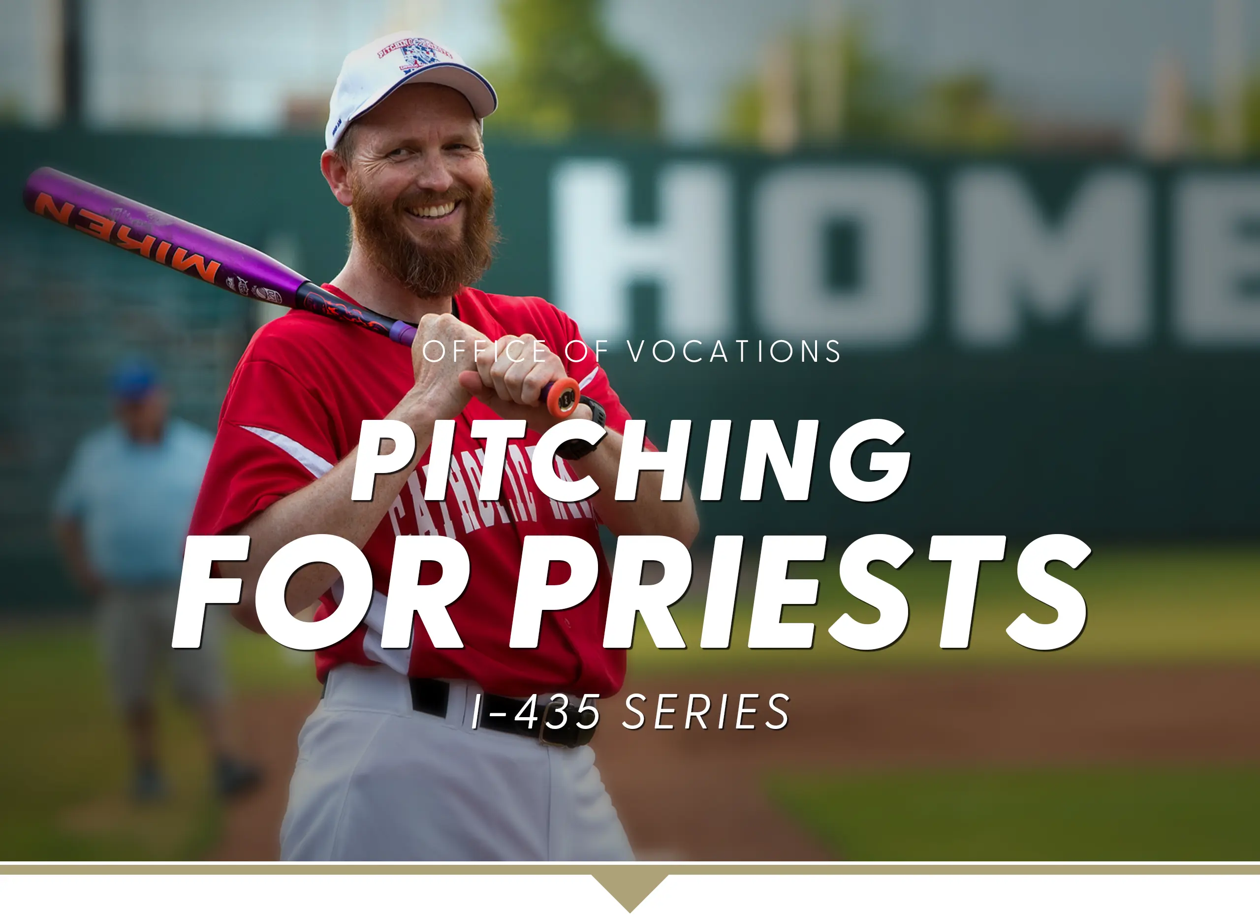 Pitching for Priests I-435 Series. Bearded man in full baseball uniform with bat on shoulder smiling at the camera on a baseball diamond.