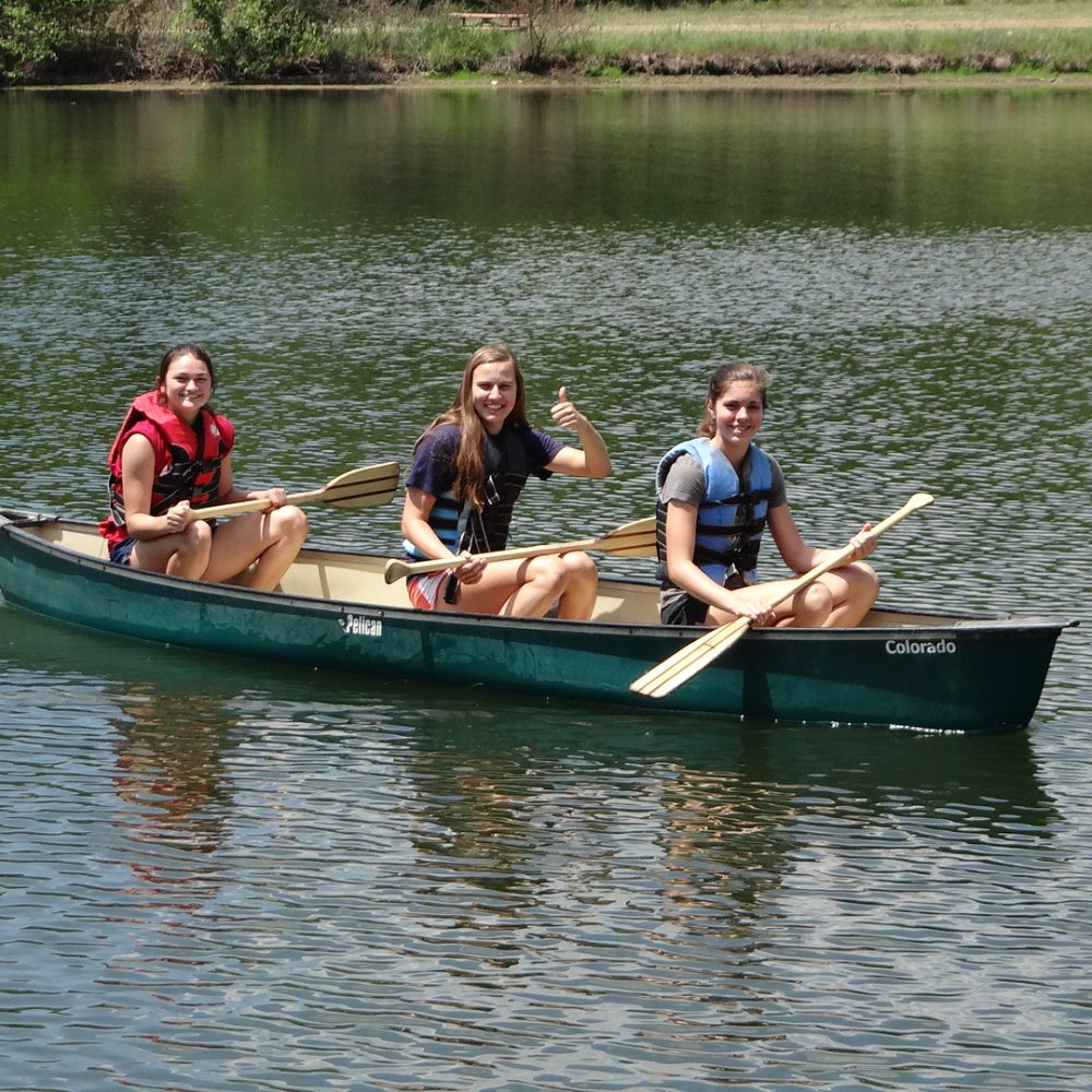 Canoe, three girls, smiling