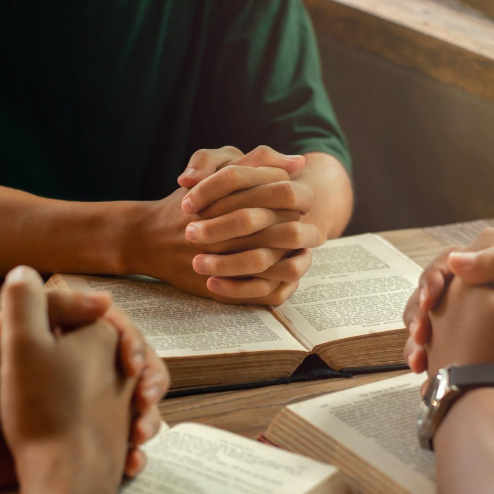 Christians join a group of cells that come together to pray and seek the blessings of God. with bible and share the gospel with copy space near the window sill in the morning